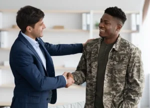 Military veteran shaking hands with a mesothelioma attorney to discuss filing both a VA claim and civil lawsuit
