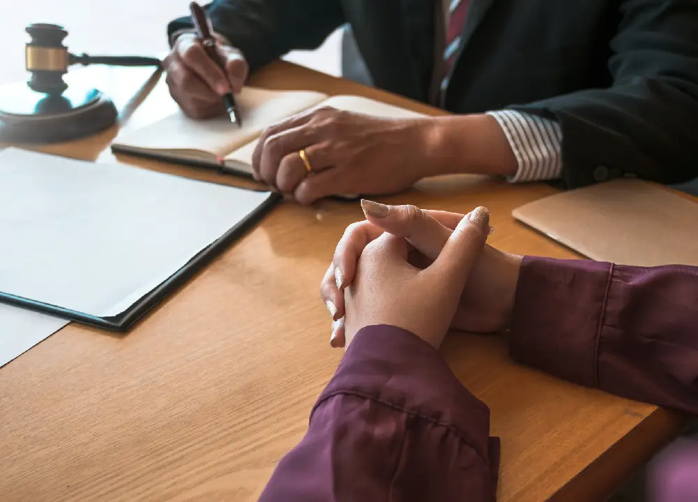 Client meeting with a lawyer reviewing documents during a legal consultation.