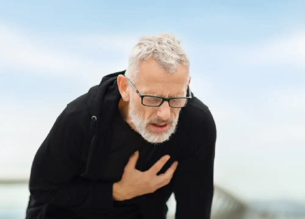 Person experiencing shortness of breath while sitting indoors.