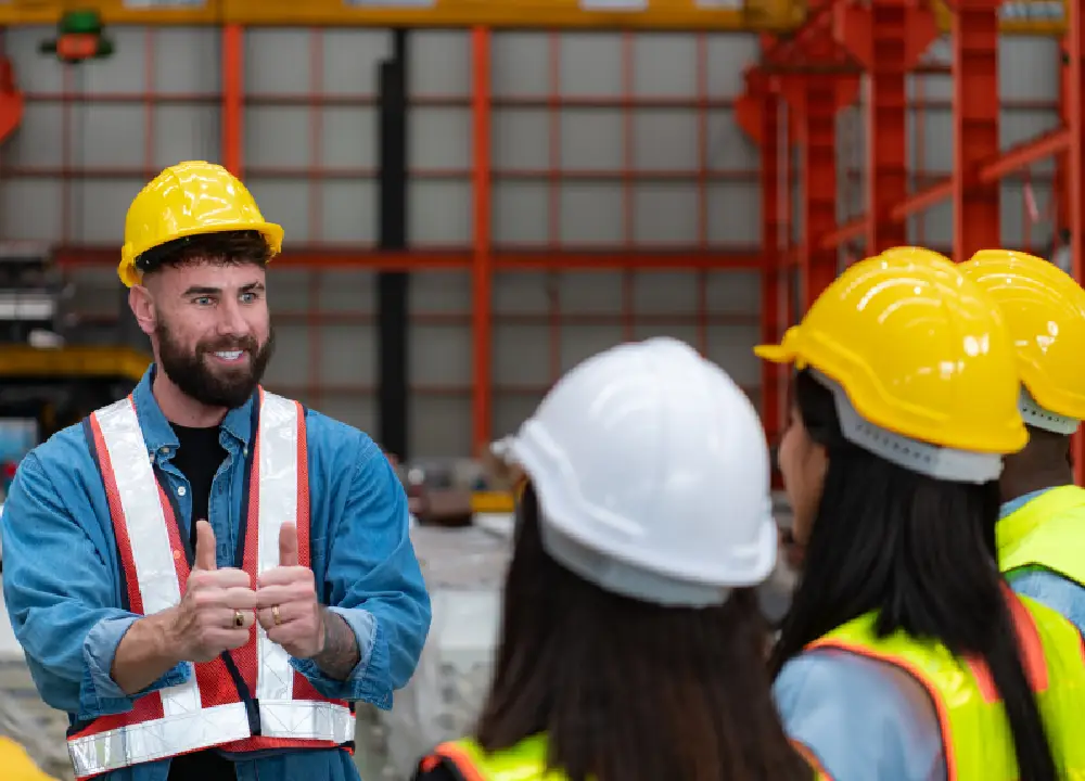 Construction workers participating in workplace safety training while wearing protective equipment