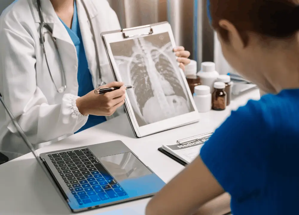 Doctor explaining mesothelioma diagnosis to patient and caregiver